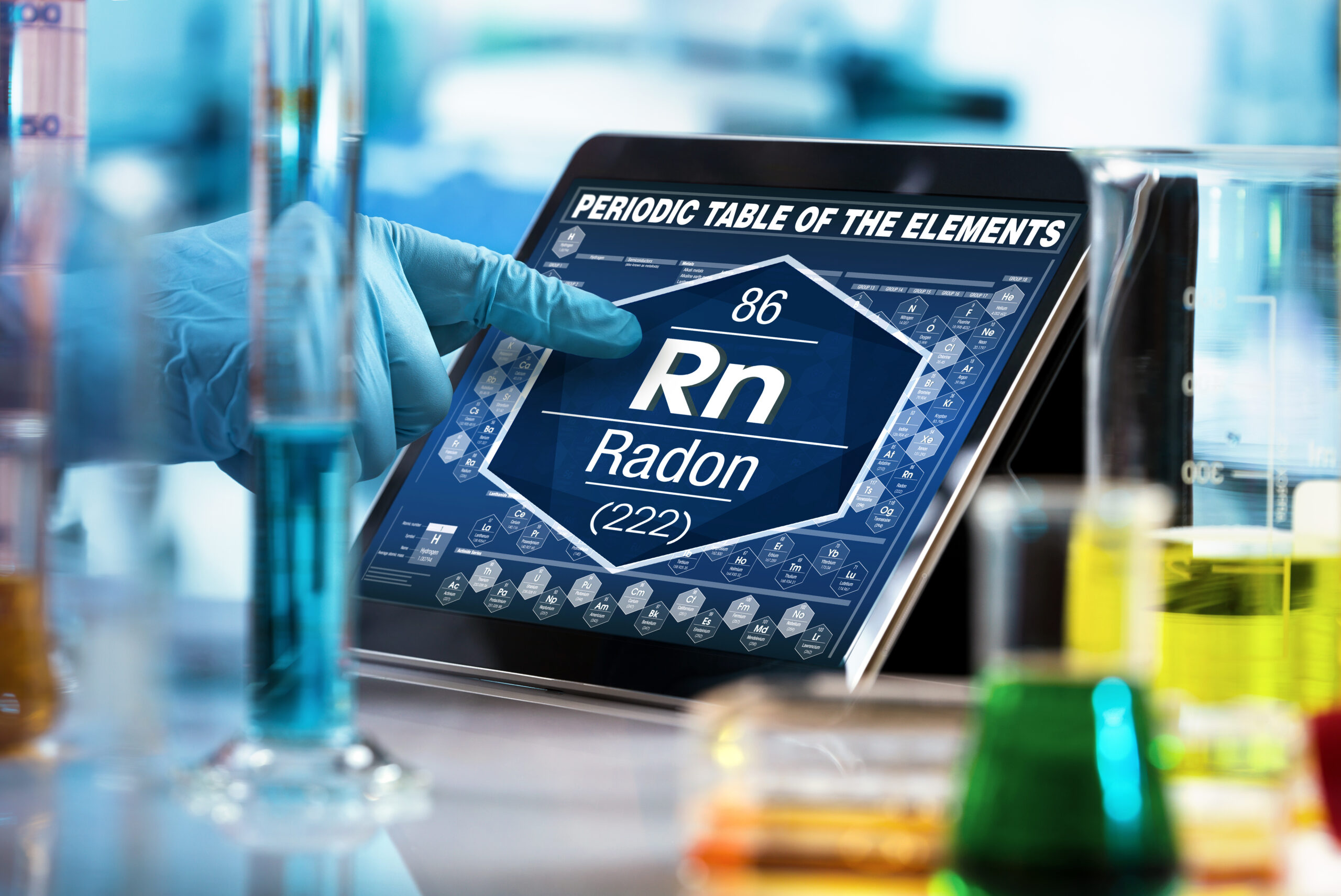 researcher working on the digital tablet data of the chemical element Radon Rn / researcher consulting information on the computer of the periodic table of elements 4 Point Home Inspection Services
